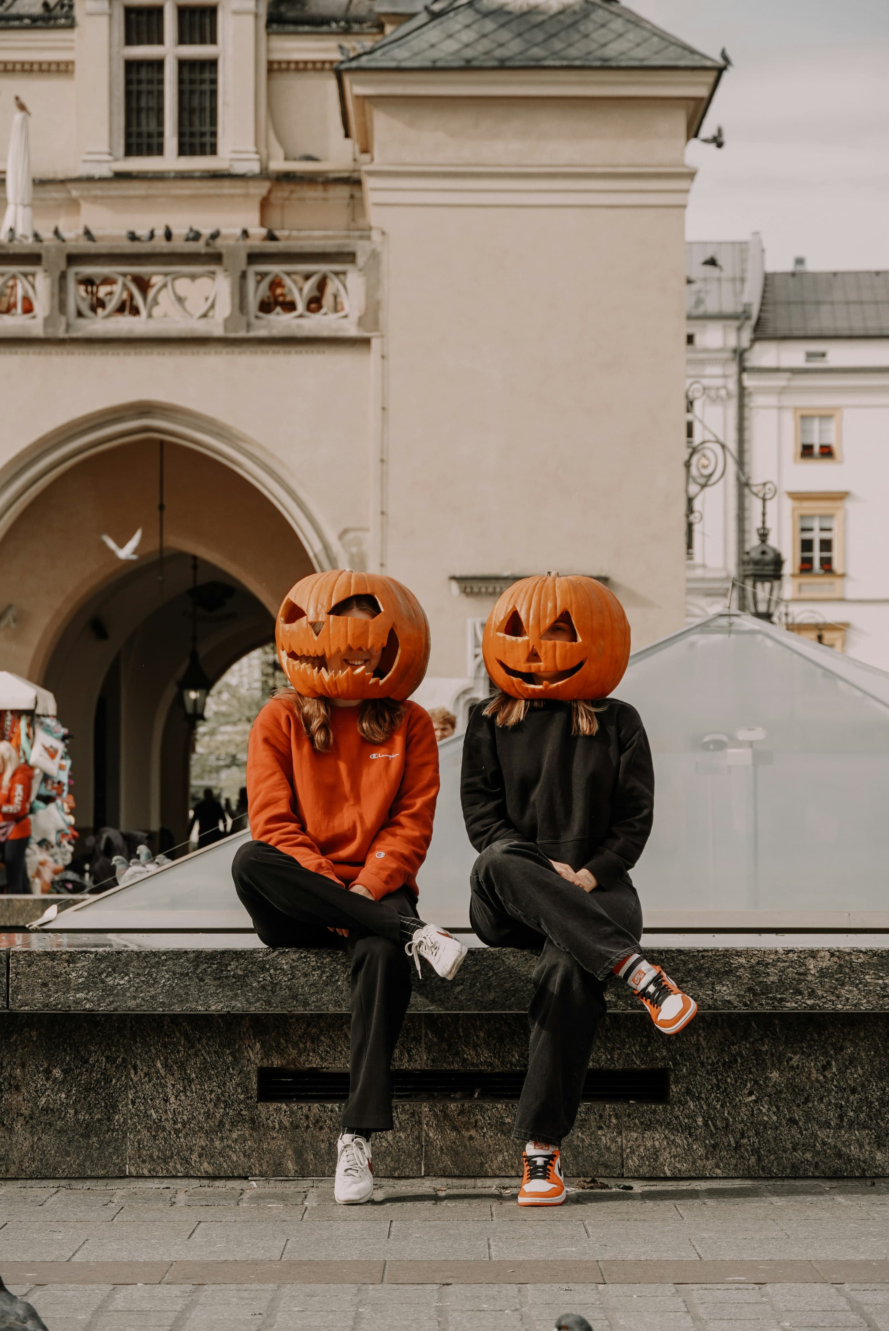 Two friends in pumpkin-head costumes